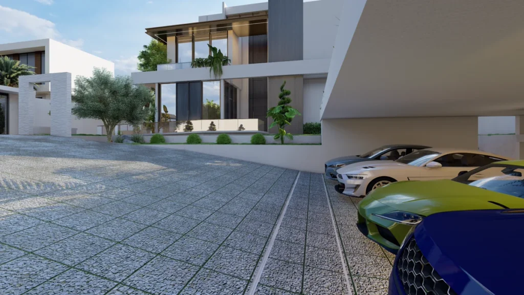 Sloped driveway and covered parking area leading to modern villa entrance with full-height glazing and greenery.