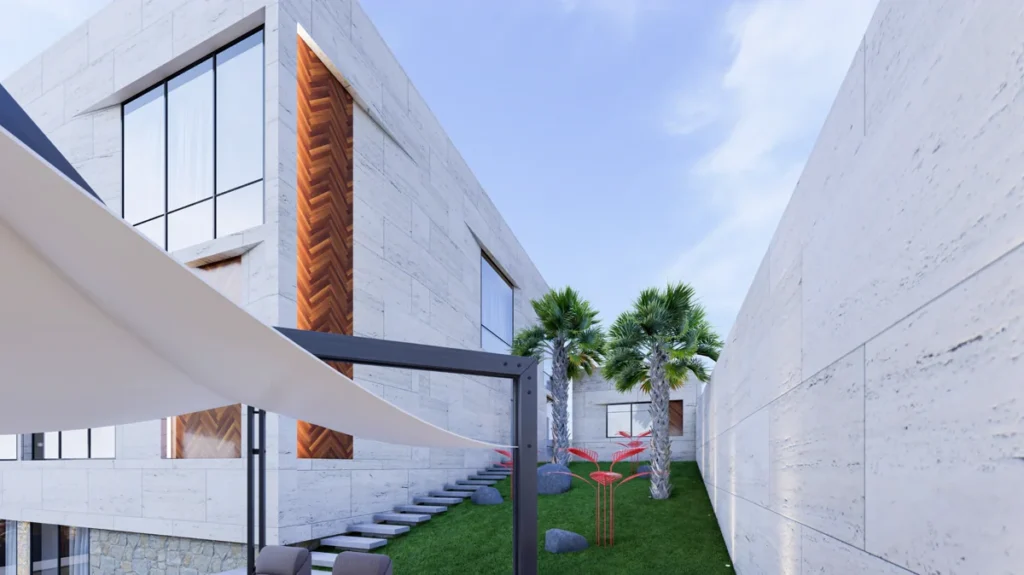 Green side garden corridor with stepping-stone path, palm trees, sculptural planting, and stone-clad villa walls.