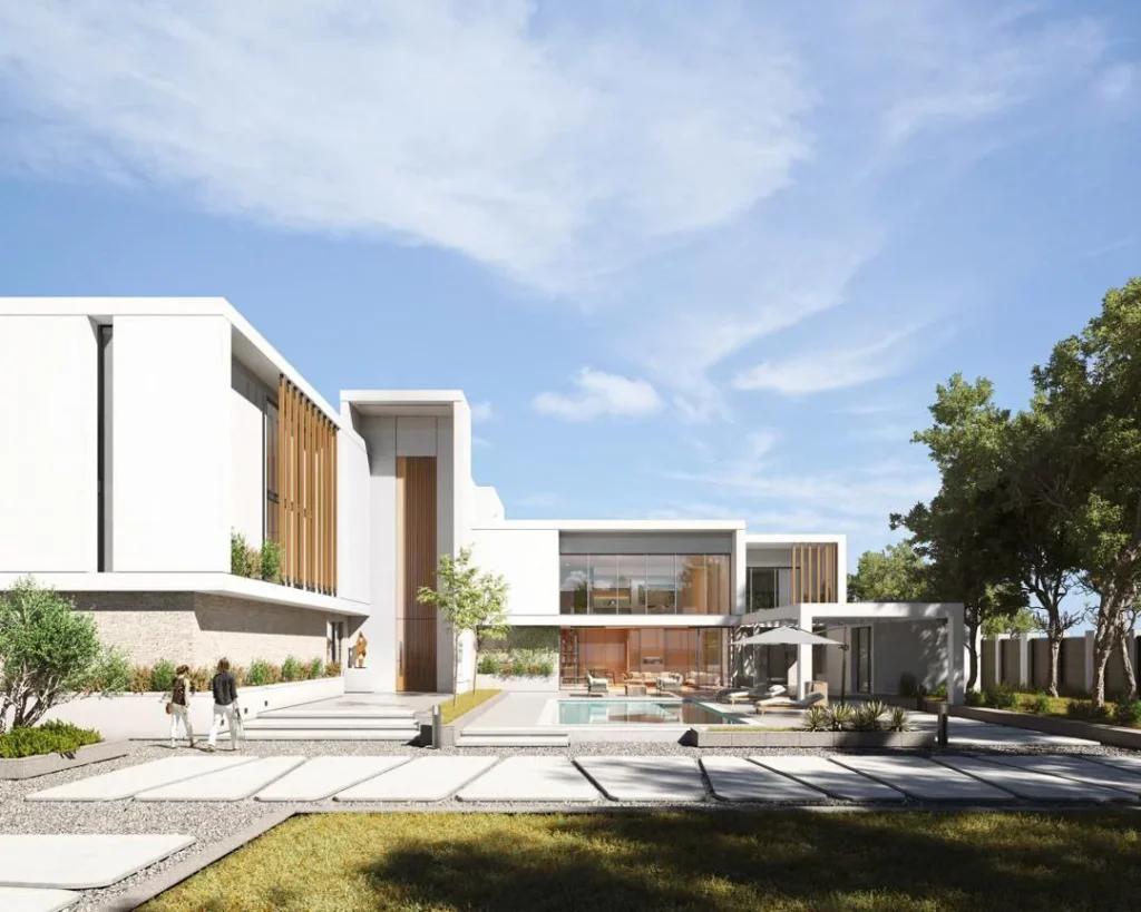 Rear garden view of the villa with pool, terraces, and expansive glazing framed by white volumes.
